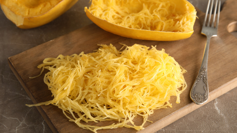 Cooked spaghetti squash on board