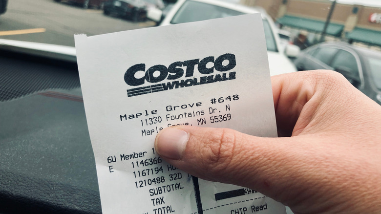Person holding a Costco receipt