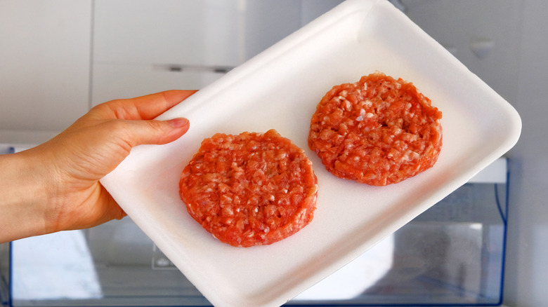 Raw burgers on a plate