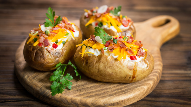 Baked potatoes on wood board