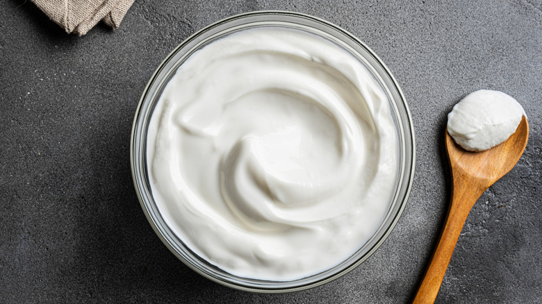 Plain Greek yogurt in bowl with spoon