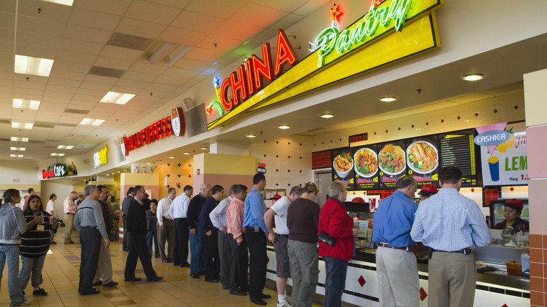 Mall food court with customers lined up