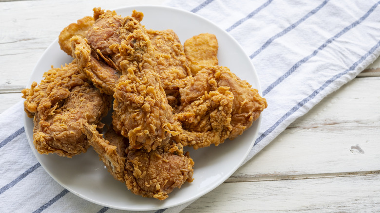 Crispy, golden fried chicken on a wooden table