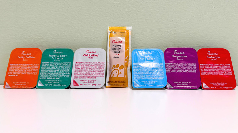 All seven Chick-fil-A sauces, in packets, lined up