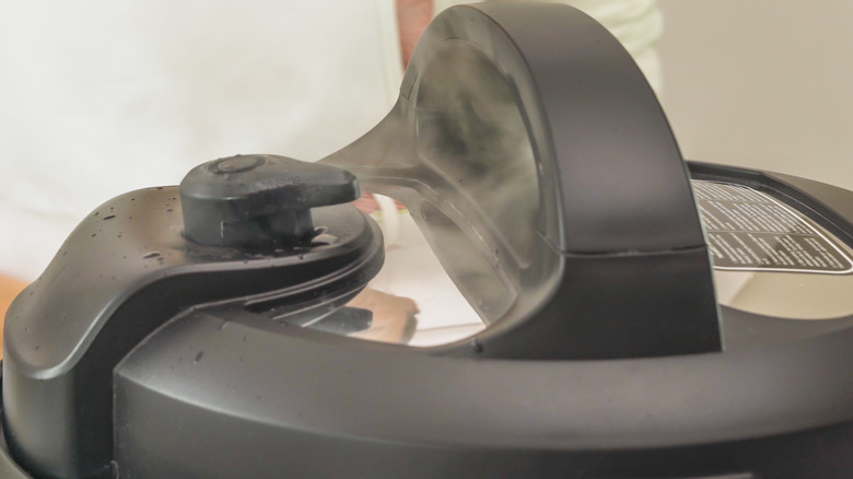 Close-up of steaming pressure cooker