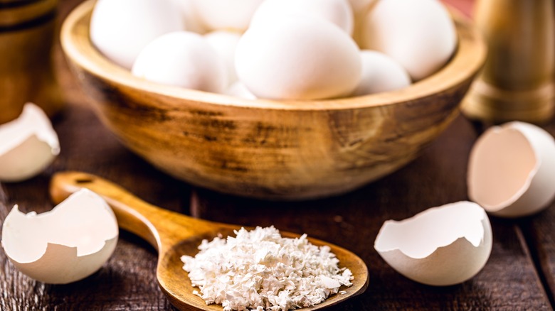 bowl of eggs with eggshells next to it