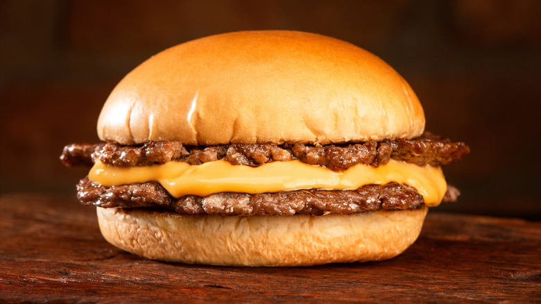 A double smash burger with one slice of melted yellow cheese