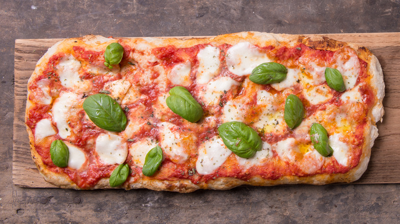 margherita pizza on cutting board