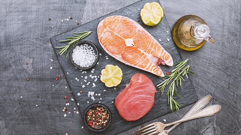 Raw salmon and tuna on cutting board