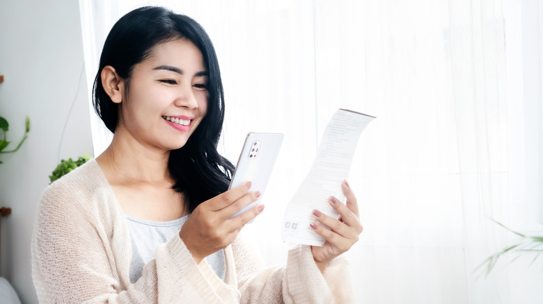 Woman taking picture of receipt
