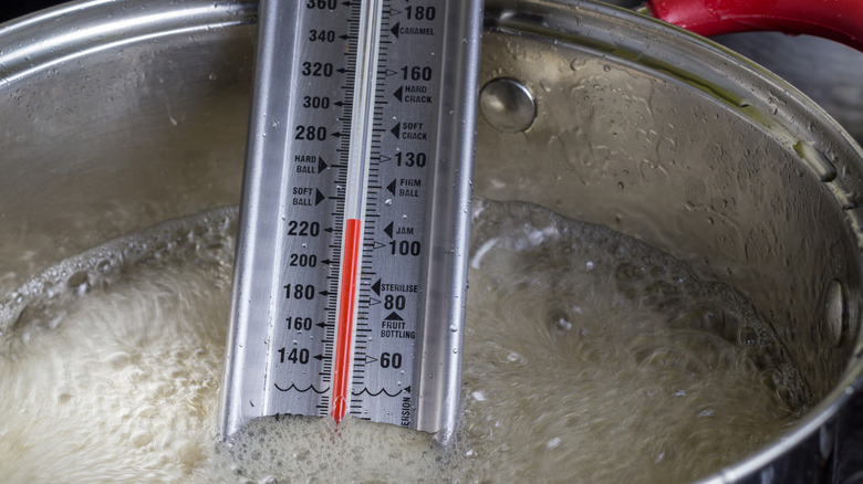 Candy thermometer in pot of boiling sugar