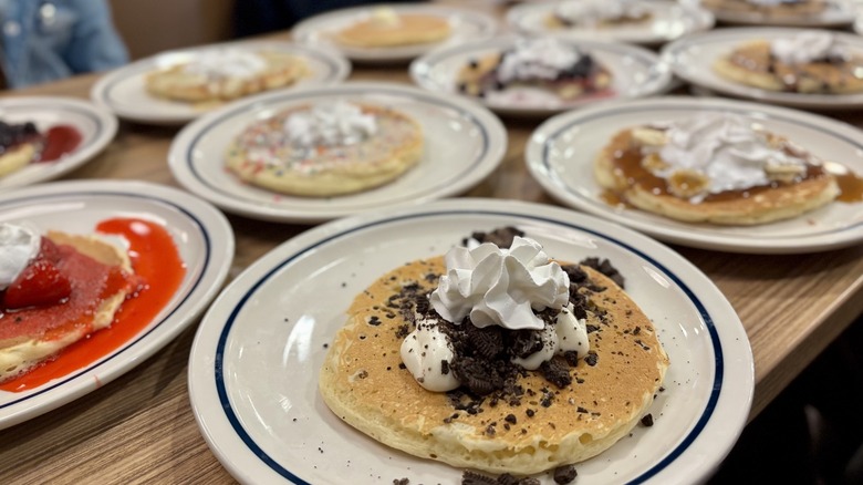 IHOP pancake types lined up on plates on table