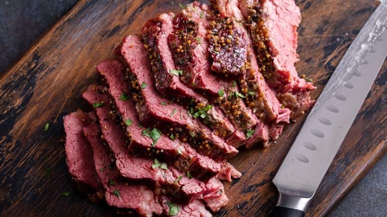 Overview of cooked and sliced corned beef on a cutting board