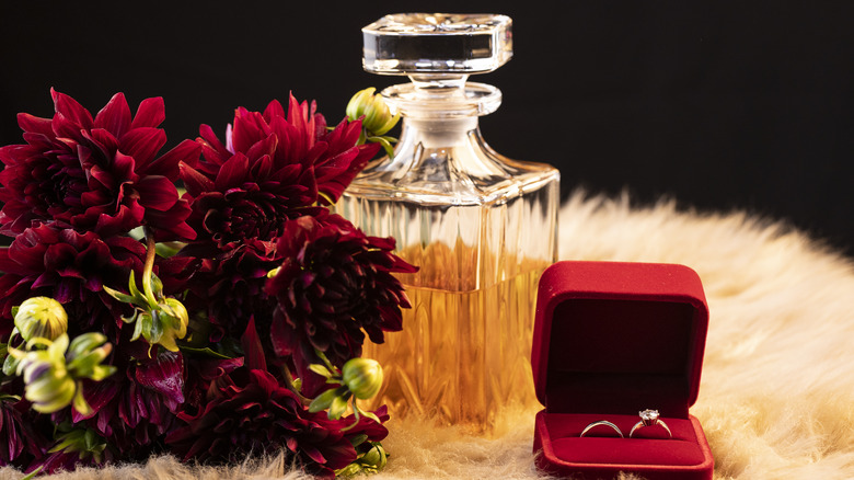 flowers, decanter, and two rings